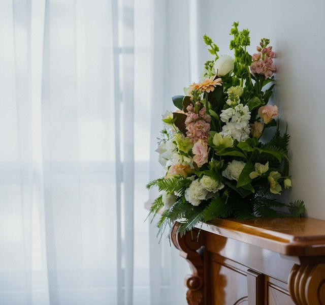 funeral director arranging flowers