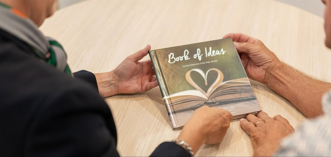 An image of an open book which has the middle pages arranged in a shape of a heart